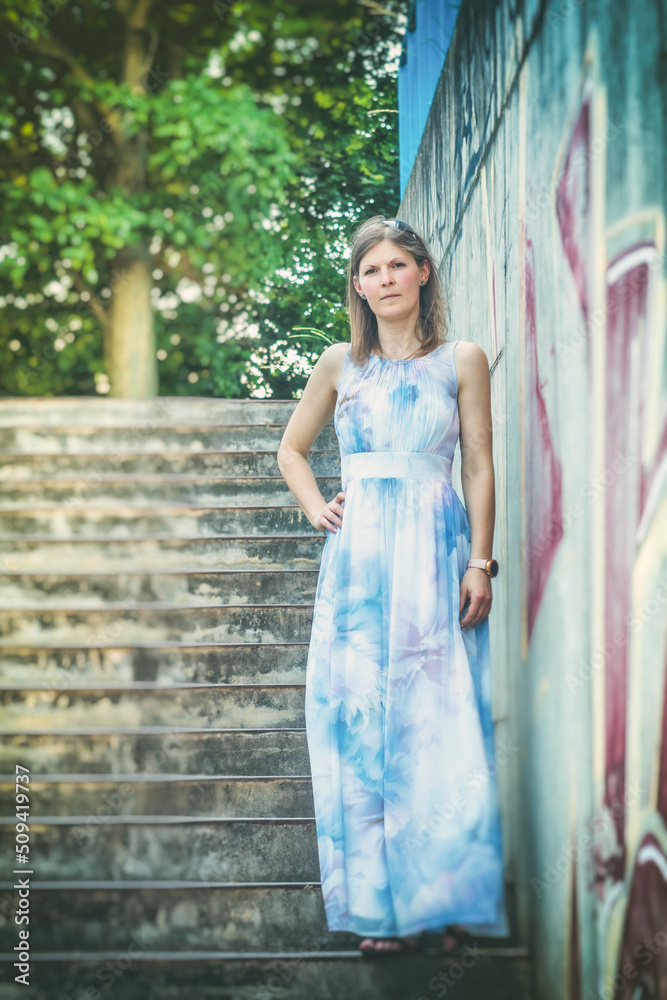Young attractive woman in a long bright dress. Portrait of a young woman in a long dress outdoors. Copy of space. Young attractive woman in a long bright dress. Portrait of a young woman in a long dress outdoors. Copy of space.