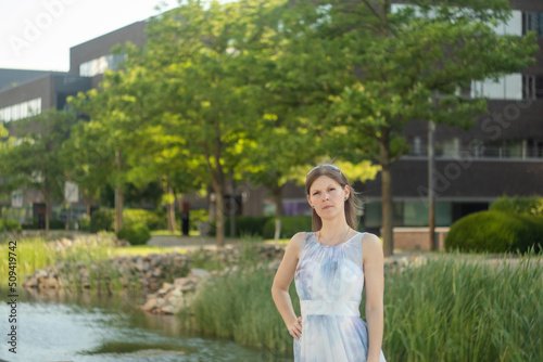 Young attractive woman in a long bright dress. Portrait of a young woman in a long dress outdoors. Copy of space.