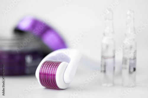 Fotobehang White microneedling derma roller with cosmetic cream