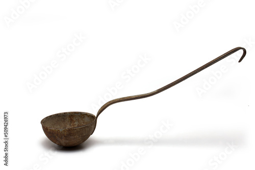 side closeup rusted old ladle white background