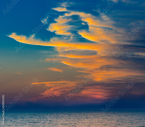 Strange sunset clouds over sea