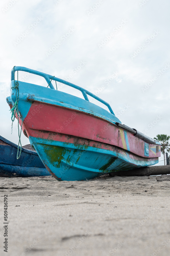 small boat anchored in the sand on the beach, means of transport and tool for fishing, background with object