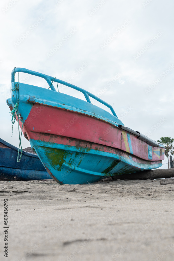 small boat anchored in the sand on the beach, means of transport and tool for fishing, background with object small boat anchored in the sand on the beach, means of transport and tool for fishing, background with object