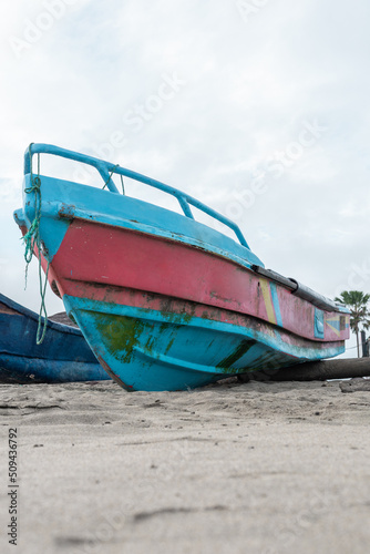 small boat anchored in the sand on the beach, means of transport and tool for fishing, background with object