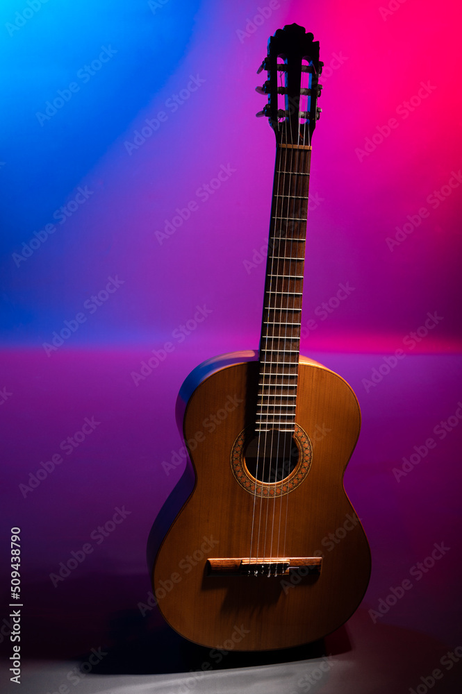 Naklejka premium Classical guitar on a colourful background with copy space