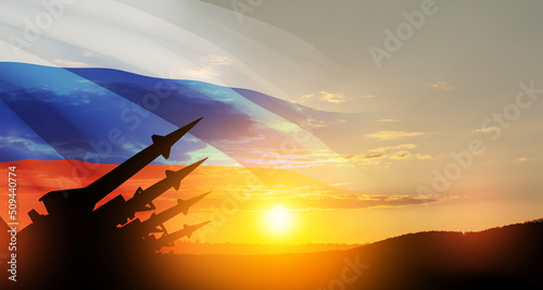 The missiles are aimed at the sky at sunset with Russian flag. Nuclear bomb, chemical weapons, missile defense, a system of salvo fire. 3d-rendering.