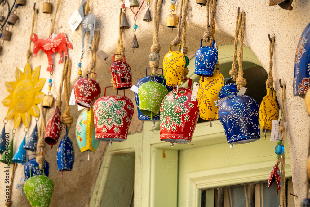 Fototapeta premium Gifts of colors typical of Santorini in Greece, bells, cats, and pendants