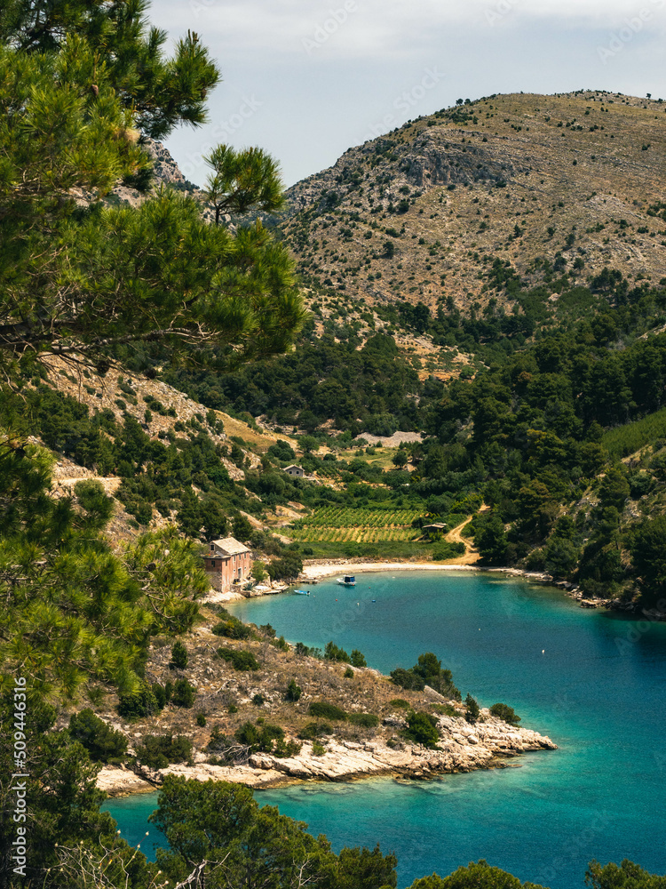 Scenery with turquoise remote beaches, plants and hills in Brac Island, Croatia