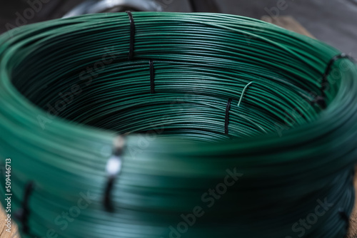 Fototapet Iron wire green in a roll. Warehouse of metal products.