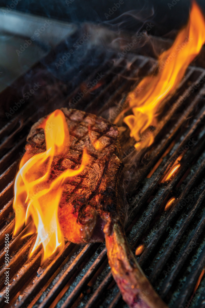 Tomahawk Steak On The Grill With Flames Tomahawk Steak On The Grill With Flames