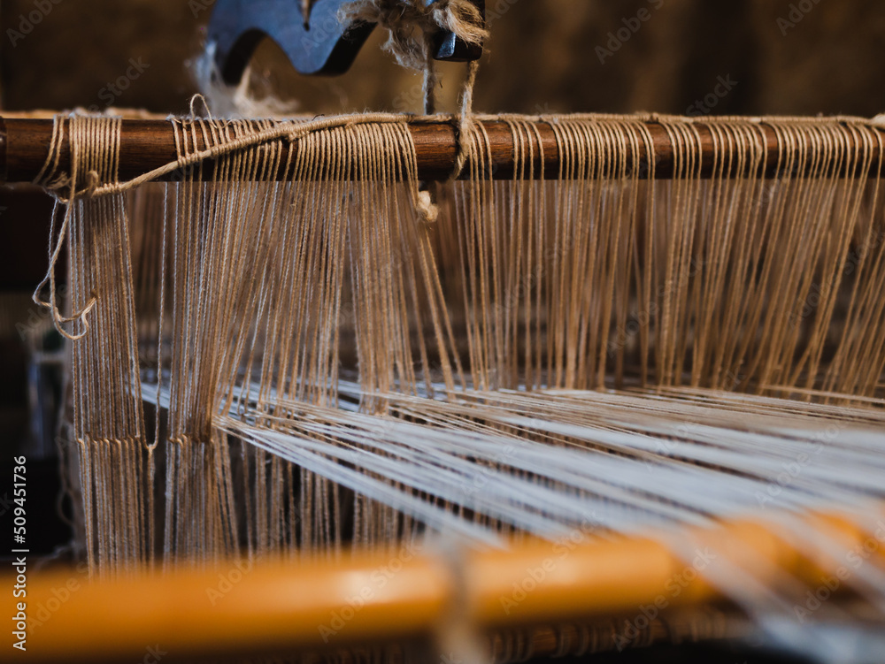 Ancient manufacturing process of spinning cotton with weaving loom in a Sicilian cave.