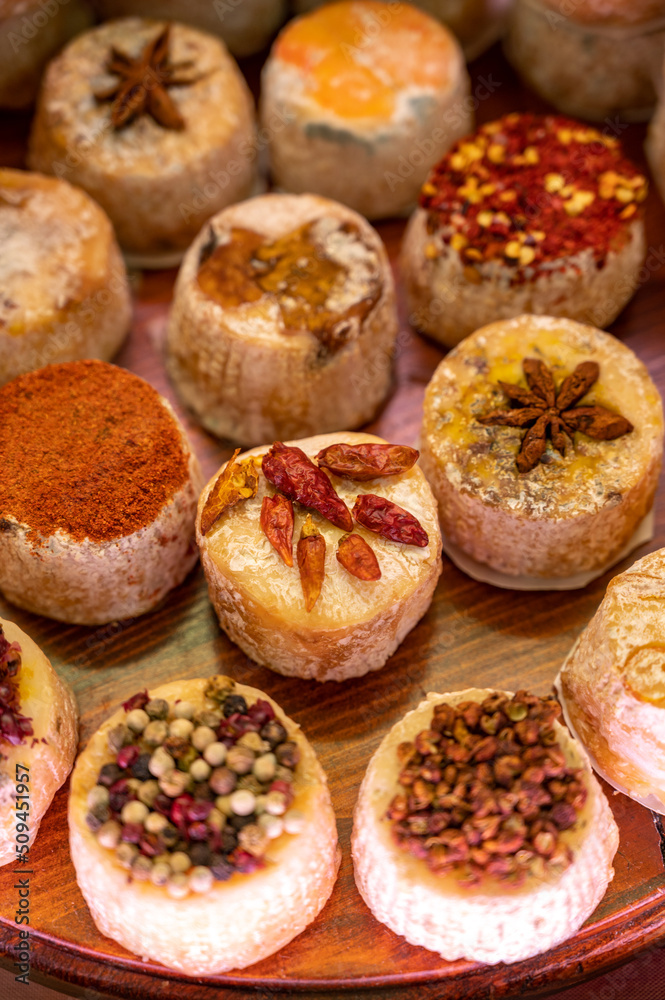 Variety of French soft goat cheese with different toppings, indian, curry, pepper, spicy Variety of French soft goat cheese with different toppings, indian, curry, pepper, spicy