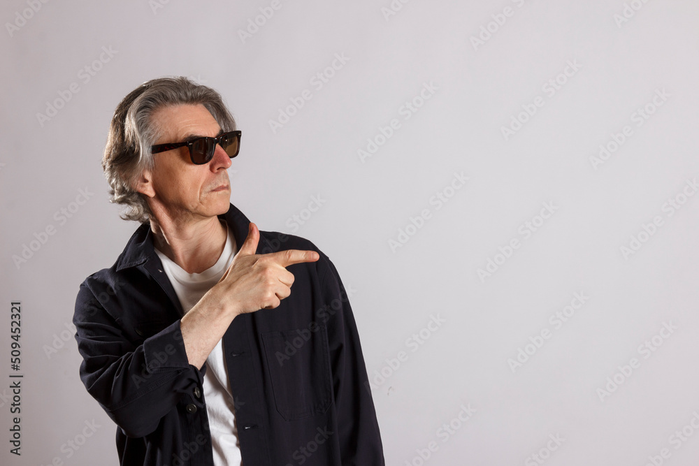 Fototapeta premium An adult man points his finger in the direction of