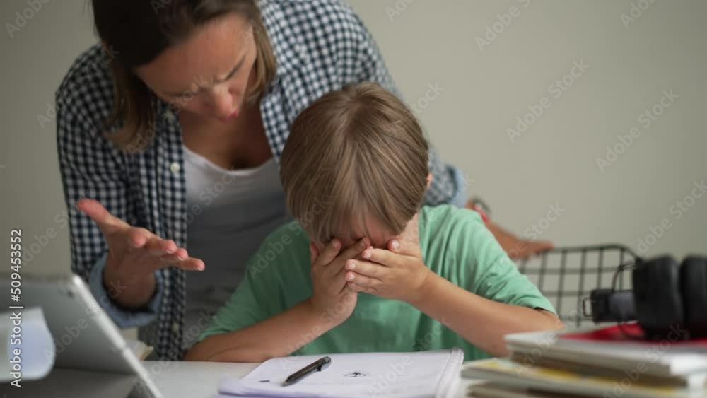 Mother and 8 year old son doing homework. Mother and 8 year old son doing homework.