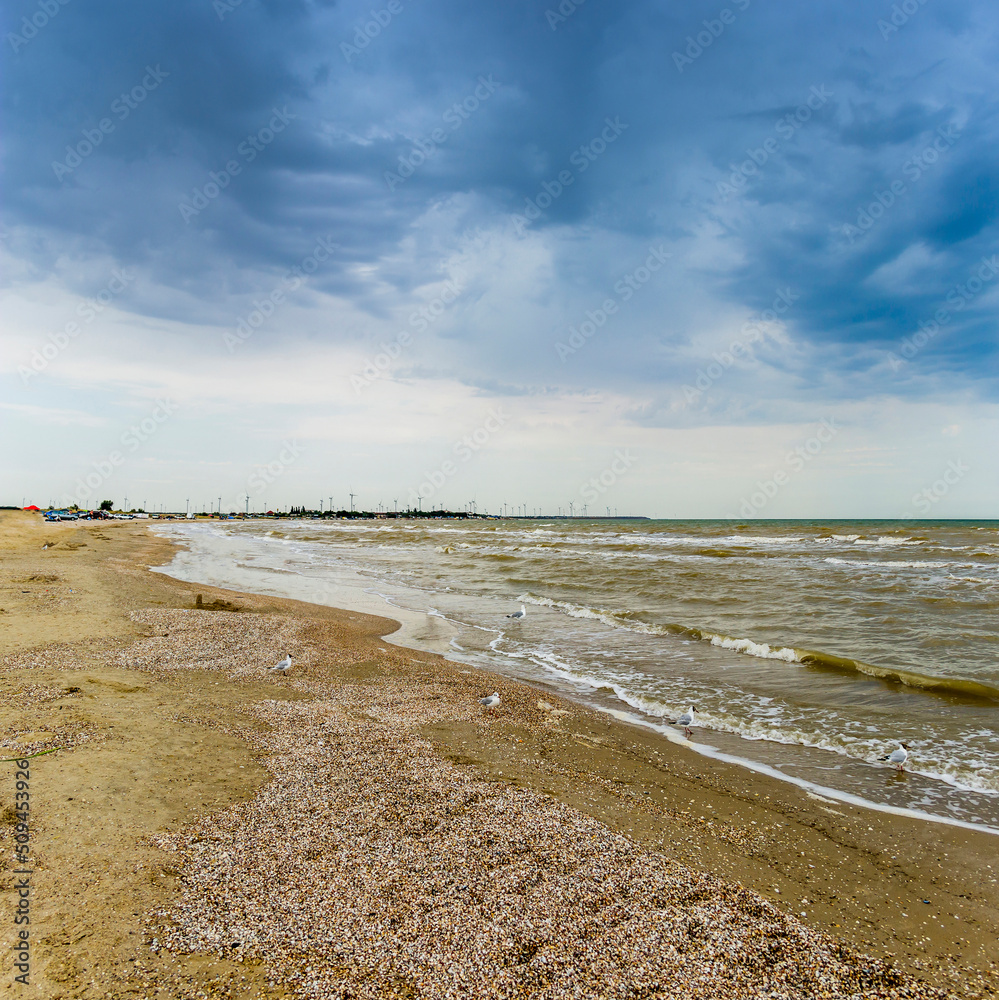 sea landscape and windmills farm on background, Azov sea, Ukraine