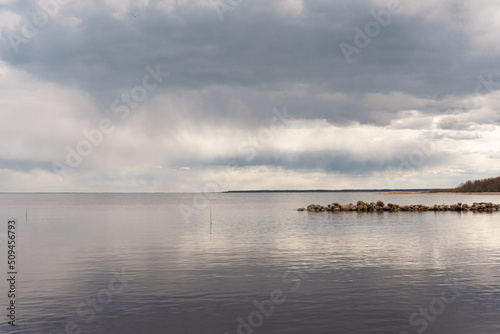 Grey sky and clouds over the lake © Kseniya
