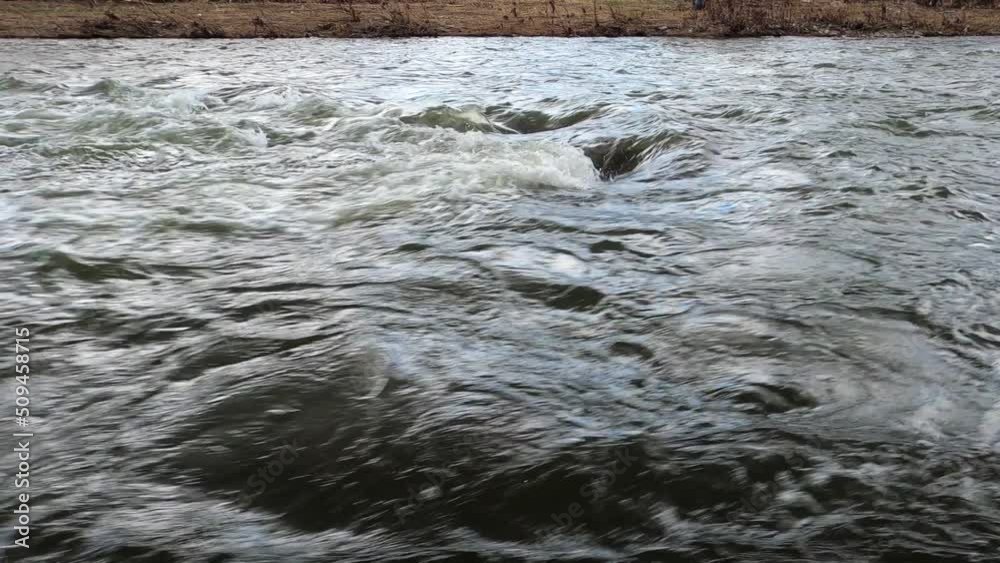 Dark flowing river water current. Dark flowing river water current.