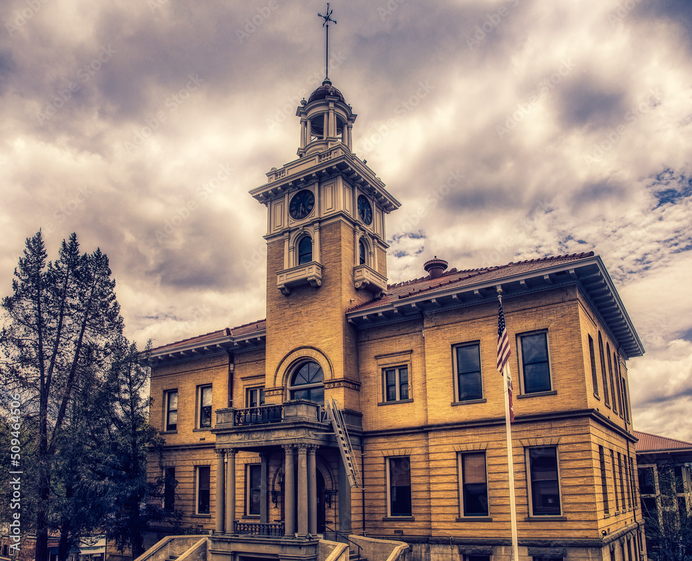 Old courthouse building in yellow with cloudy sky