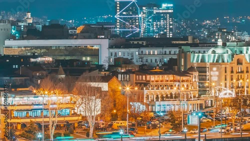 Tbilisi, Georgia. Hith tower building above Urban Cityscape during evening night lights. Elevated view Tbilisi skyline Time timelapse. night video. photo