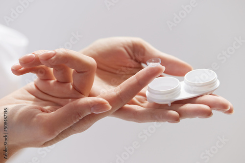 Contact Eye Lenses. Woman Hands Holding Contact Eye Lens. Woman Hands Holding White Container. Beautiful Woman Fingers Holding Eye Lens Box. Health And Eyes Care Concept. High Resolution © puhhha
