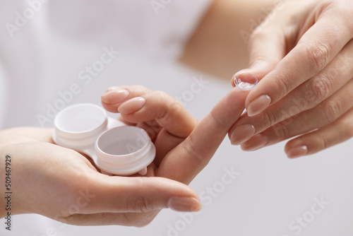 Contact Eye Lenses. Woman Hands Holding Contact Eye Lens. Woman Hands Holding White Eye lens Container. Beautiful Woman Fingers Holding Eye Lens Box. Health And Eyes Care Concept. High Resolution