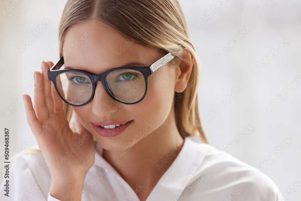 Female Eyeglasses. Portrait Of Young Woman Wearing Fashion Eyewear. Blonde Female Model In Fashion Eye Glasses With Natural Face Makeup. Good Vision Concept Female Eyeglasses. Portrait Of Young Woman Wearing Fashion Eyewear. Blonde Female Model In Fashion Eye Glasses With Natural Face Makeup. Good Vision Concept