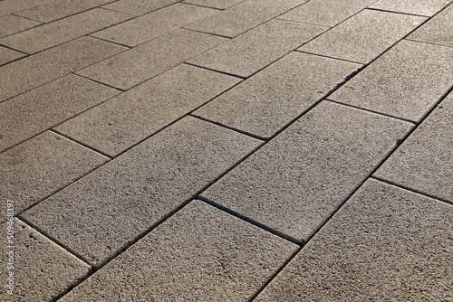 Fotografia, Obraz Stone pavement texture, cobbled street in sunlight