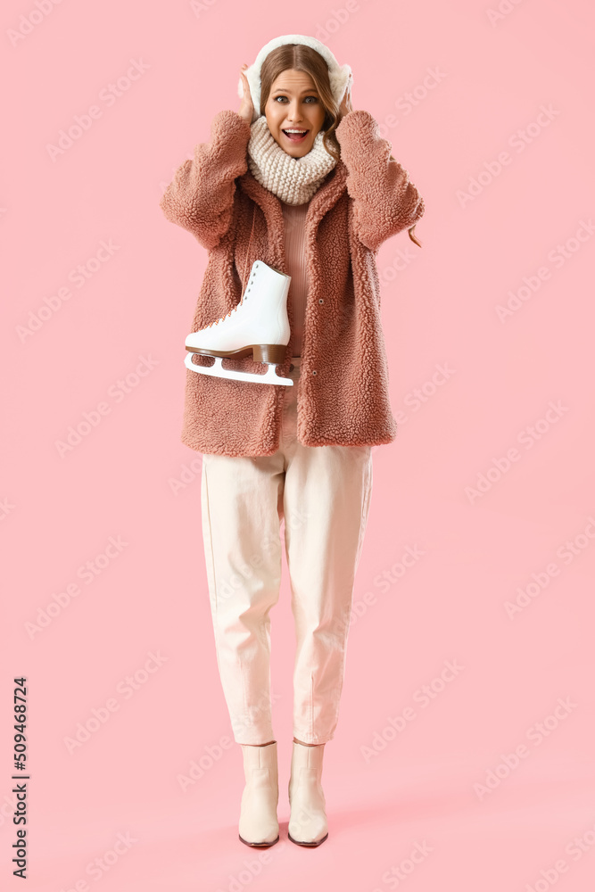 Beautiful happy young woman with ice skates on pink background Beautiful happy young woman with ice skates on pink background