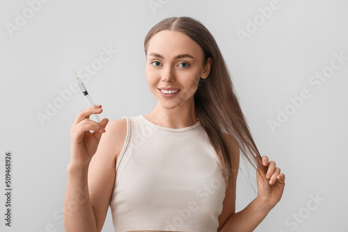 Young woman with hair loss ...