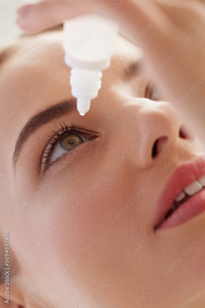 Woman With Eye Drops. Closeup Of Girl Applying Eye Drops In Eyes. Young Female Model With Natural Makeup Using A Bottle Of Eye Drops. Health Concept. High Resolution