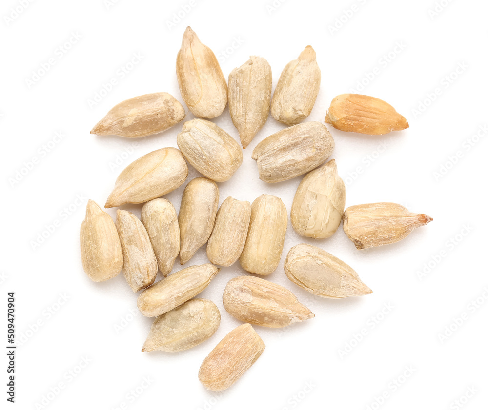 Peeled sunflower seeds on white background, top view Peeled sunflower seeds on white background, top view