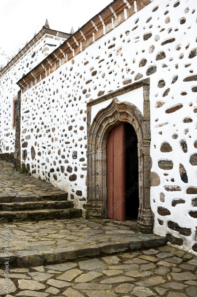 Lateral facade and ornamental door of the sanctuary of San Andrés de Teixido. Galicia, Spain, Europe.