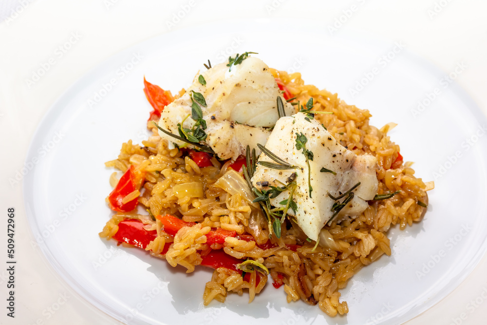 Fish dish - fried cod fillet with boiled white rice and fresh fruit salsa on white table Fish dish - fried cod fillet with boiled white rice and fresh fruit salsa on white table
