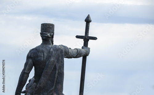 Back view of the monument to King Erekle II with a sword in his hand against the sky. Telavi, Georgia photo