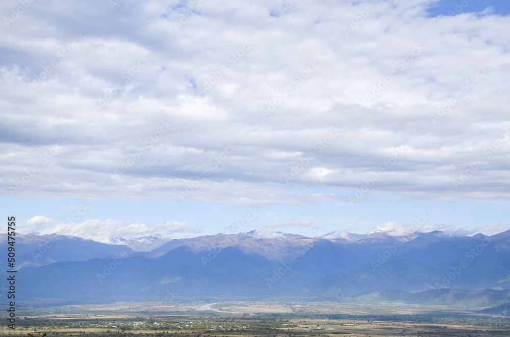 Scenery view to Alazani valley and Caucasian Mountain range at the distance from Telavi city, Kakheti region, Georgia