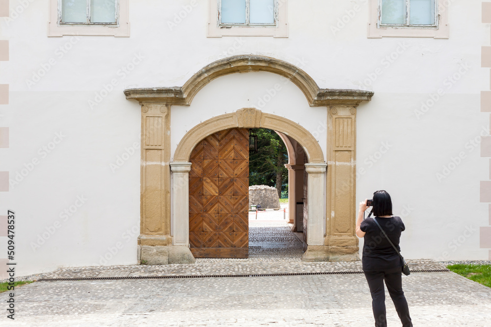 Tourist photographer taking pictures with camera of museum of Matije Gupca, Croatia