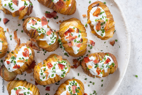baked potato stuffed with cheese, bacon and sour cream. loaded hasselback potatoes