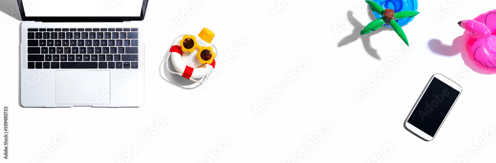 © Tierney - Laptop computer with summer theme items - flat lay © Tierney - Laptop computer with summer theme items - flat lay