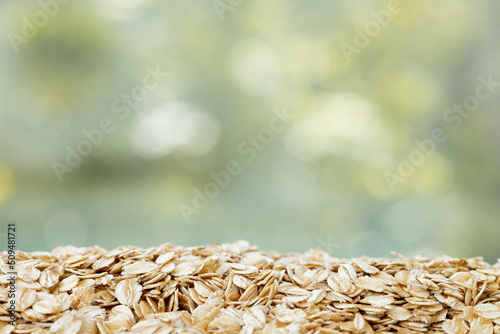 Close up of oats isolated on green summer background. Healthy food.