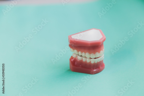 3d render of invisalign removable and invisible retainer over blue green  background photo