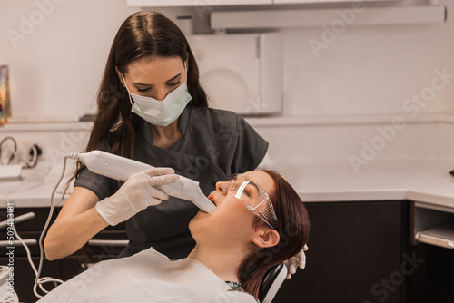 Orthodontist scaning patient with dental intraoral scanner. Prosthodontics and stomatology concept.