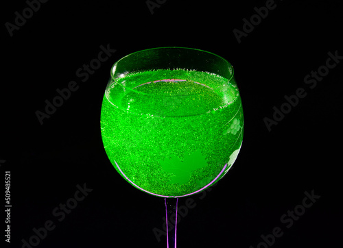 Midori sour cocktail - close up photo in a darkness. Background picture.