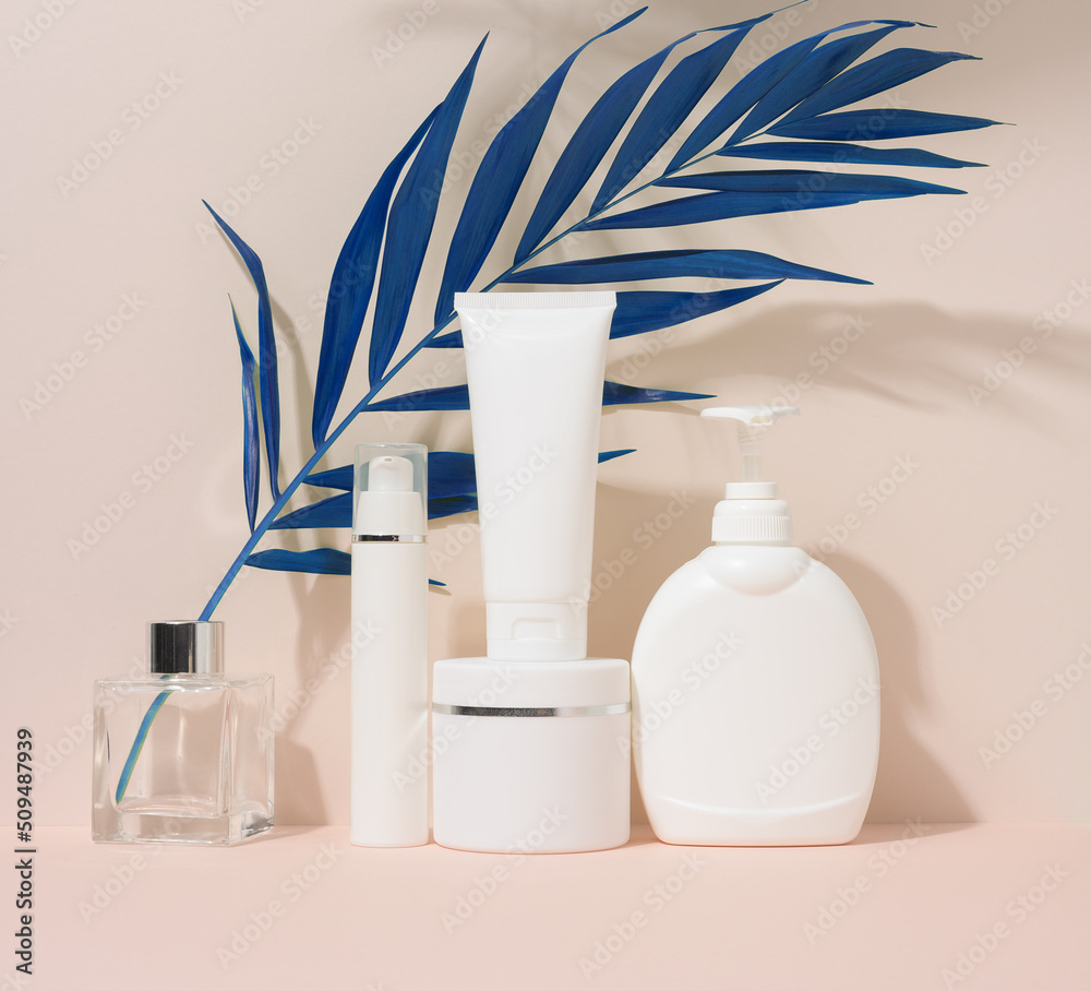 White plastic container tube, a jar with a lid and a container with a dispenser for cosmetics White plastic container tube, a jar with a lid and a container with a dispenser for cosmetics