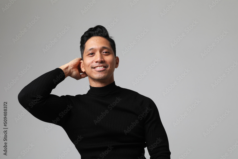 Headshot of positive Asian man posing on white wall. Concept of businessman. 