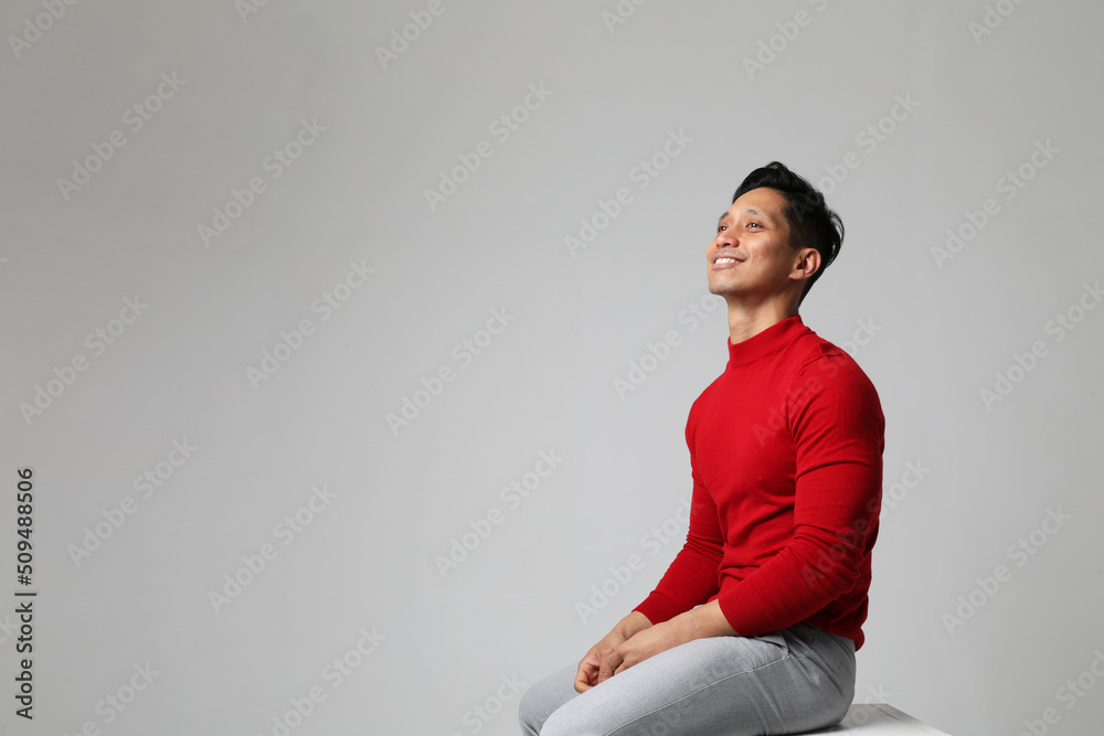 Positive Asian young man posing near white wall. Concept of businessman. Mock up Positive Asian young man posing near white wall. Concept of businessman. Mock up