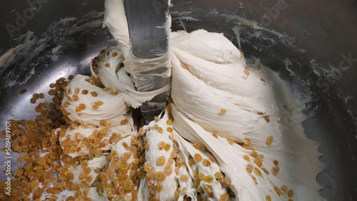 Obraz na płótnie Close-up of dough with raisins in mixer
