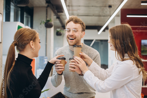 Businessman serving coffee to colleagues in office
