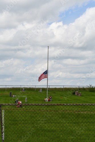 Flag at Half Staff in a Cemetery