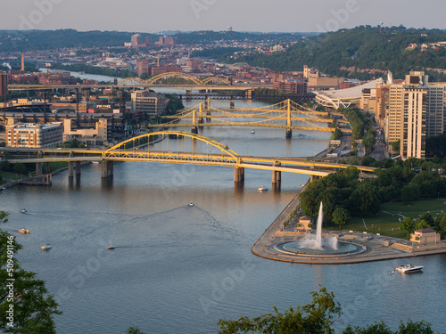 Yellow bridges across the Allegheny River with Point State Park Fountain in Pittsburgh, Pennsylvania (PA), USA.