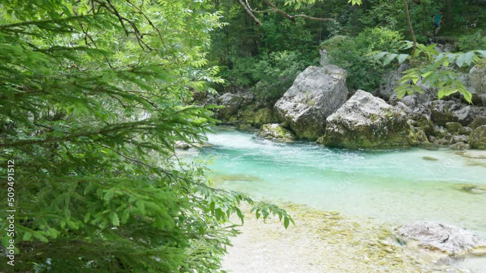 Turquoise river Soca and green forest in the mountains of Triglav national park. Bright sunny spring day. Turquoise river Soca and green forest in the mountains of Triglav national park. Bright sunny spring day.